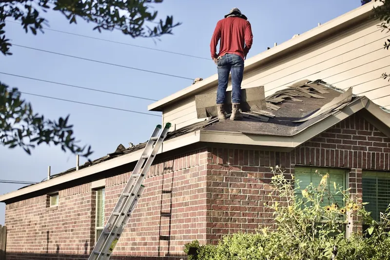 Professional roofer working on a residential roof in Darien